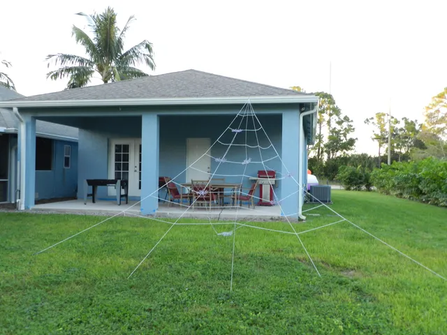 a view of a house with a yard and sitting area