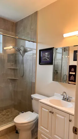 a bathroom with a sink a toilet and shower