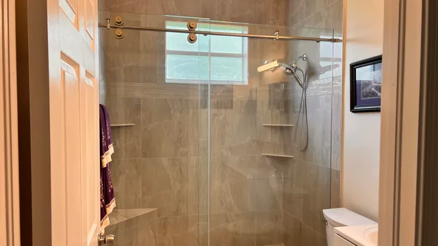 a bathroom with a shower and a toilet