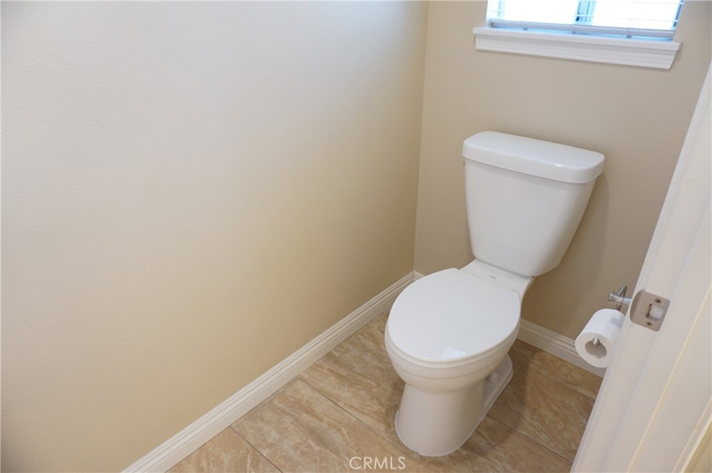 19584 Shadow Glen Circle Porter Ranch, CA 91326 - Photo 31 of 72 a white toilet sitting next to a white wall
