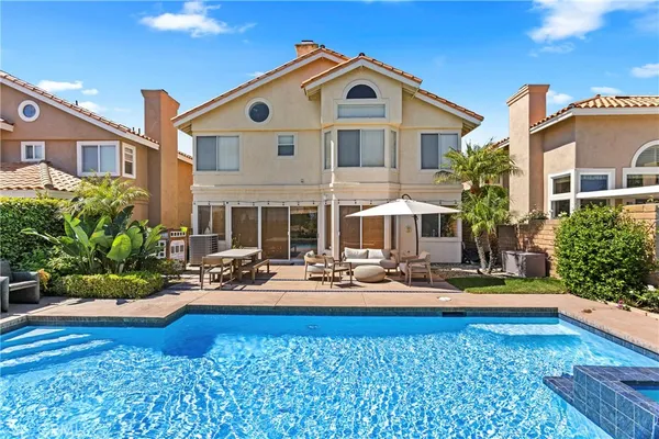 a front view of house with yard and swimming pool