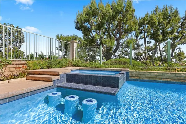 a front view of a house with swimming pool having outdoor seating