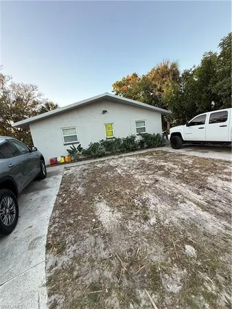 a backyard of a house with cars parked