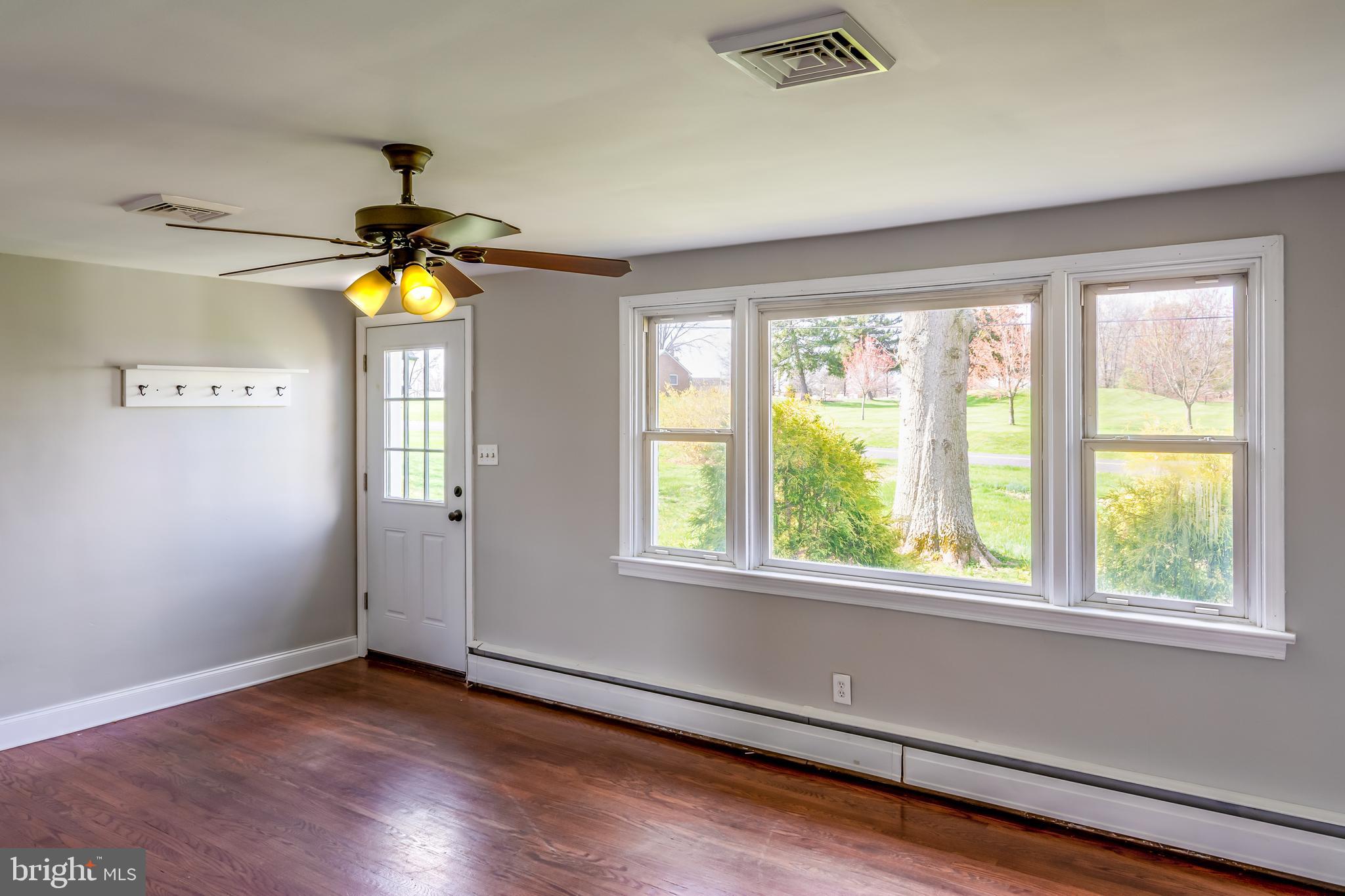 737 Rising Sun Road Telford, PA 18969 - Photo 2 of 21 a view of an empty room with window and chandelier fan
