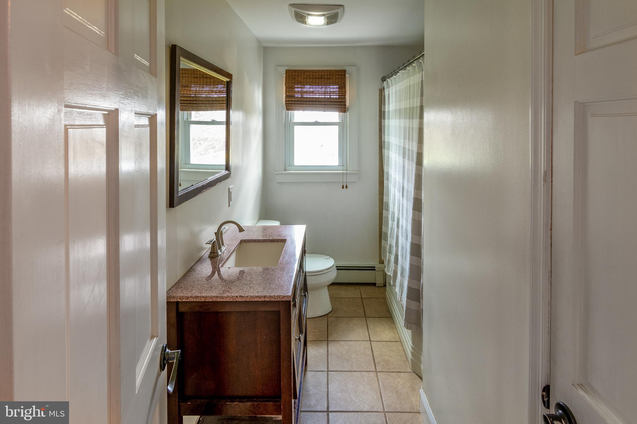 737 Rising Sun Road Telford, PA 18969 - Photo 13 of 21 a bathroom with a sink mirror and a toilet