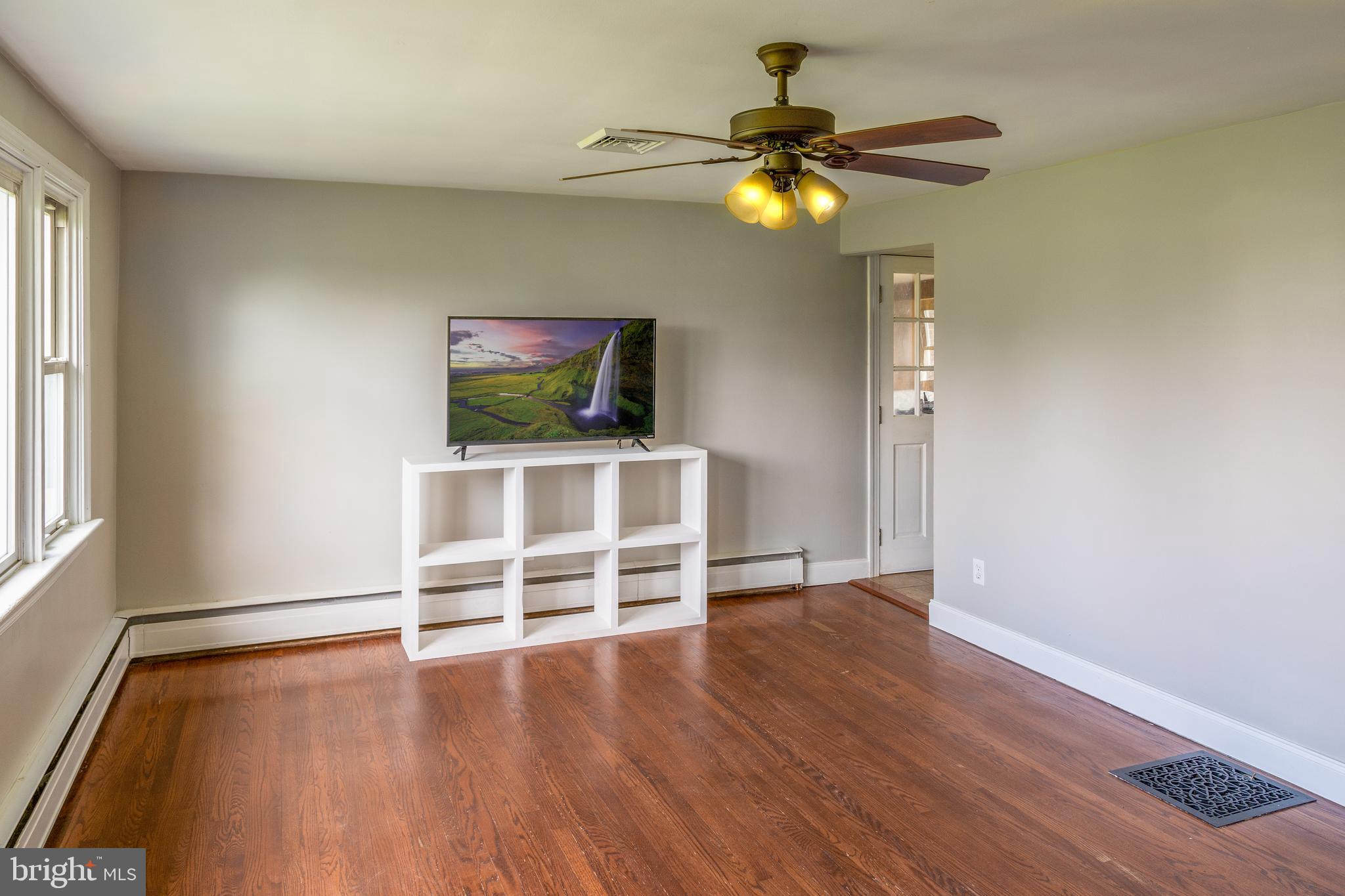 737 Rising Sun Road Telford, PA 18969 - Photo 4 of 21 a view of a livingroom with wooden floor and a ceiling fan