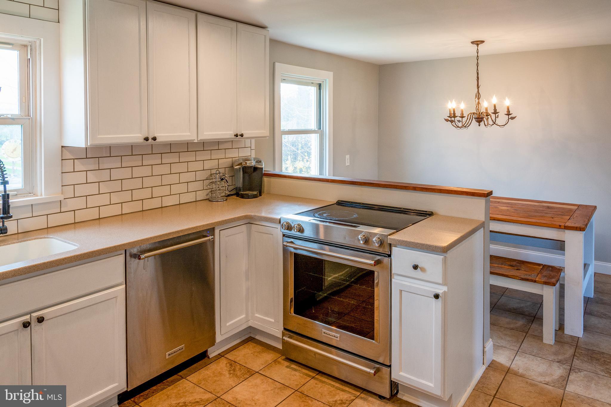 737 Rising Sun Road Telford, PA 18969 - Photo 7 of 21 a kitchen with stainless steel appliances granite countertop a sink a stove and a window