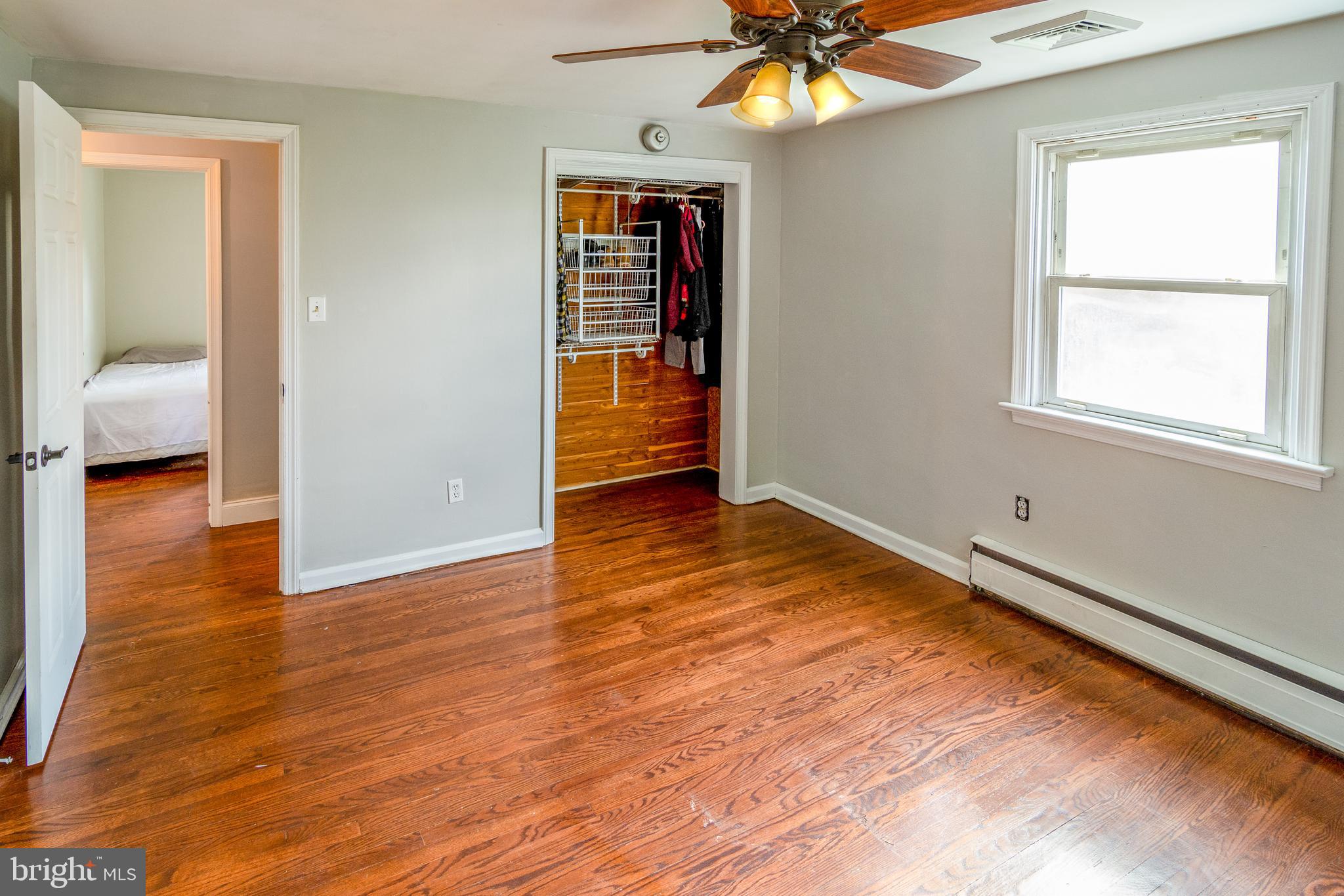 737 Rising Sun Road Telford, PA 18969 - Photo 9 of 21 a view of an empty room with wooden floor and a window