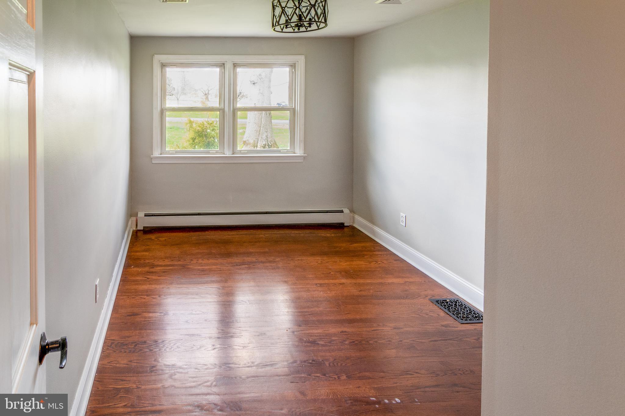 737 Rising Sun Road Telford, PA 18969 - Photo 10 of 21 an empty room with wooden floor and windows