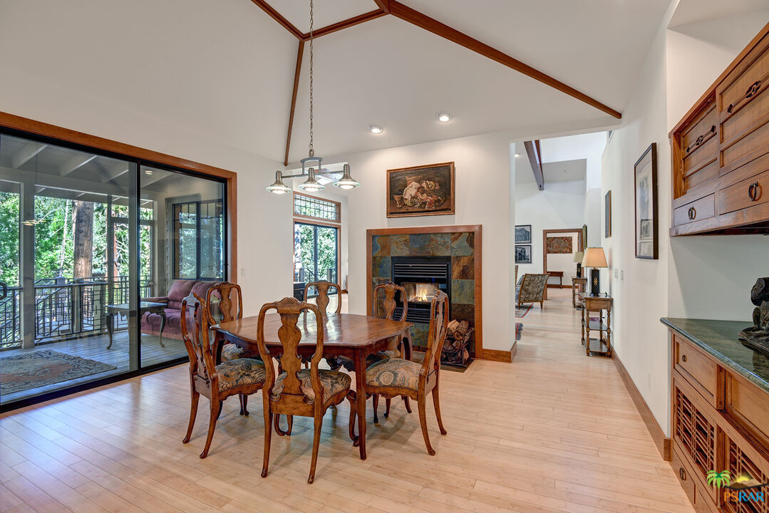 25445 Fern Valley Road Idyllwild, CA 92549 - Photo 20 of 52 a dining room with furniture a fireplace and wooden floor