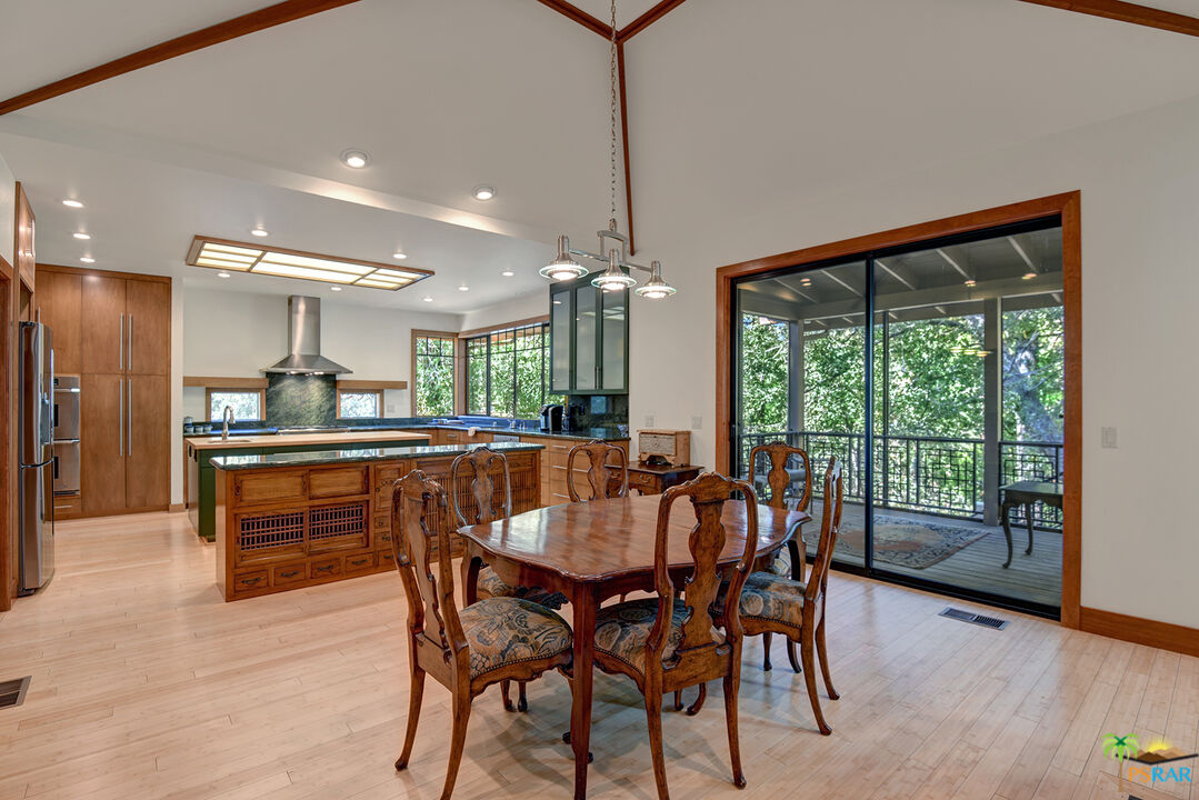 25445 Fern Valley Road Idyllwild, CA 92549 - Photo 21 of 52 a dining area with a table chairs and a kitchen view