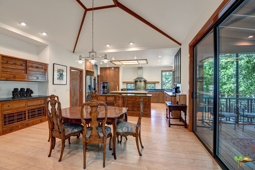 25445 Fern Valley Road Idyllwild, CA 92549 - Photo 22 of 52 a dining area with stainless steel appliances kitchen island granite countertop a dining table and chairs