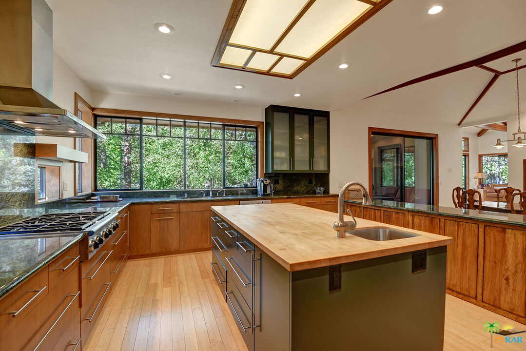 25445 Fern Valley Road Idyllwild, CA 92549 - Photo 24 of 52 a kitchen with kitchen island a counter space a sink and appliances