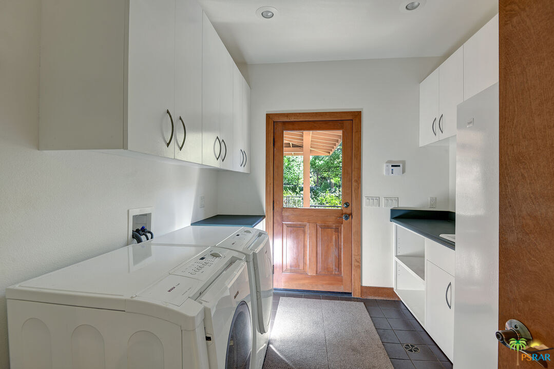 25445 Fern Valley Road Idyllwild, CA 92549 - Photo 28 of 52 a utility room with cabinets washer and dryer
