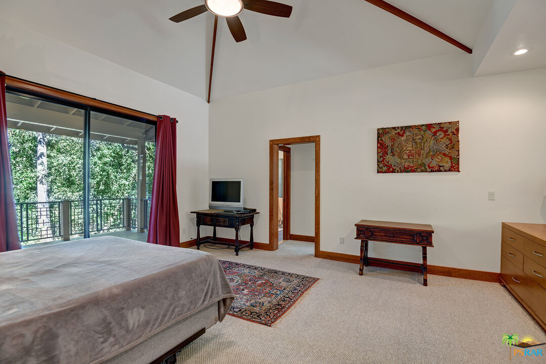 25445 Fern Valley Road Idyllwild, CA 92549 - Photo 33 of 52 a bedroom with a bed a chair and a large window