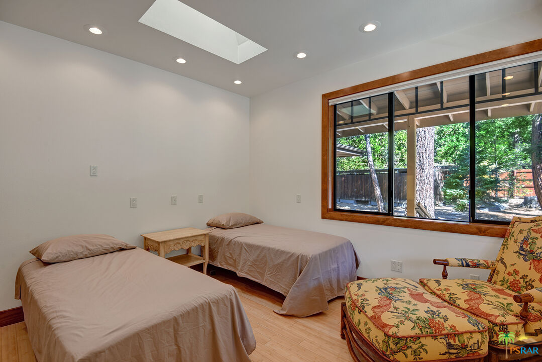 25445 Fern Valley Road Idyllwild, CA 92549 - Photo 43 of 52 a bedroom with two beds and a large window