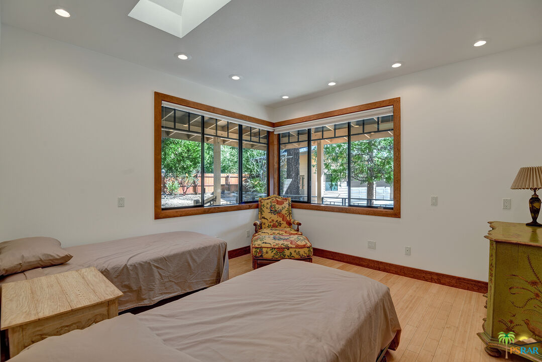 25445 Fern Valley Road Idyllwild, CA 92549 - Photo 44 of 52 a bedroom with a large bed and a large window