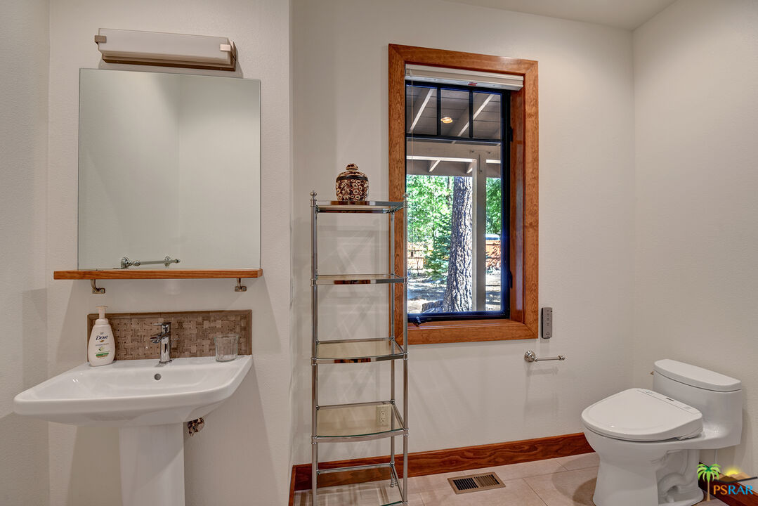 25445 Fern Valley Road Idyllwild, CA 92549 - Photo 47 of 52 a bathroom with a toilet sink and mirror