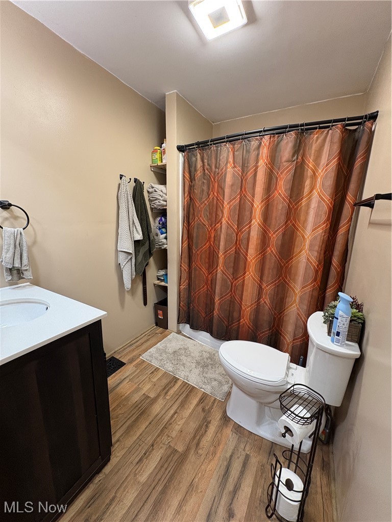 4542 Bloomfield Road Cambridge, OH 43725 - Photo 14 of 22 Full bath featuring vanity, curtained shower, and light wood-style flooring