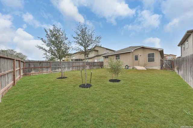 a view of a house with a backyard
