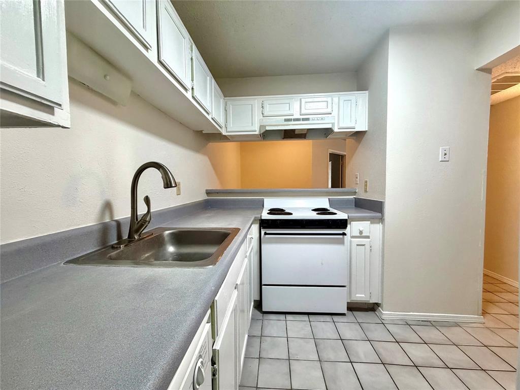 18333 Roehampton Drive, Unit 624 Dallas, TX 75252 - Photo 16 of 39 a kitchen with a sink appliances and cabinets