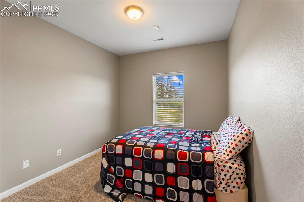 6040 Big Sky Drive Rye, CO 81069 - Photo 12 of 50 a bedroom with a bed and a chandelier