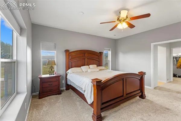 a bathroom with a granite countertop double vanity sink and a mirror