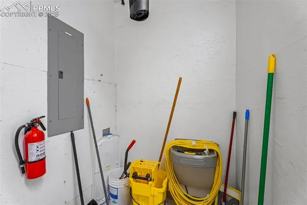 a storage room with lots of chairs a washer and dryer