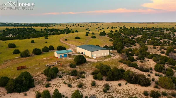 a view of a terrace with wooden floor and a floor to ceiling window