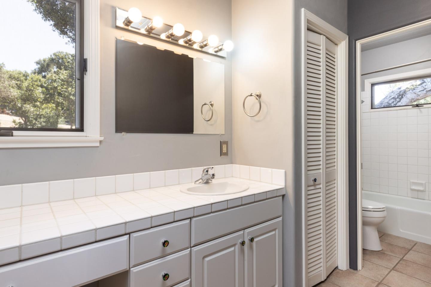 21 La Rancheria Carmel Valley, CA 93924 - Photo 17 of 44 a bathroom with a sink a toilet and a mirror
