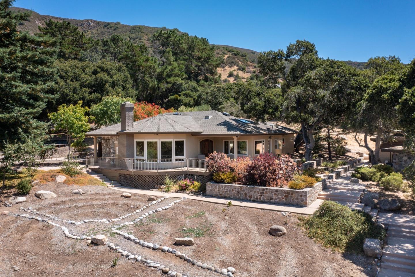 21 La Rancheria Carmel Valley, CA 93924 - Photo 2 of 44 a front view of a house with a yard