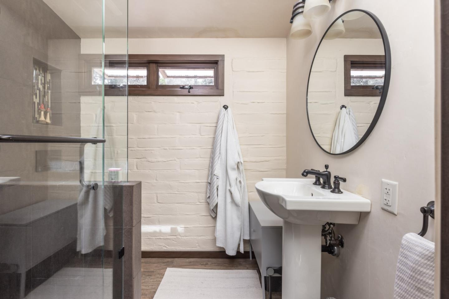 21 La Rancheria Carmel Valley, CA 93924 - Photo 21 of 44 a bathroom with a sink a mirror and a shower