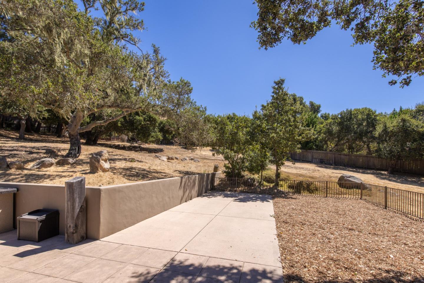 21 La Rancheria Carmel Valley, CA 93924 - Photo 29 of 44 a view of a terrace with a bench and trees around