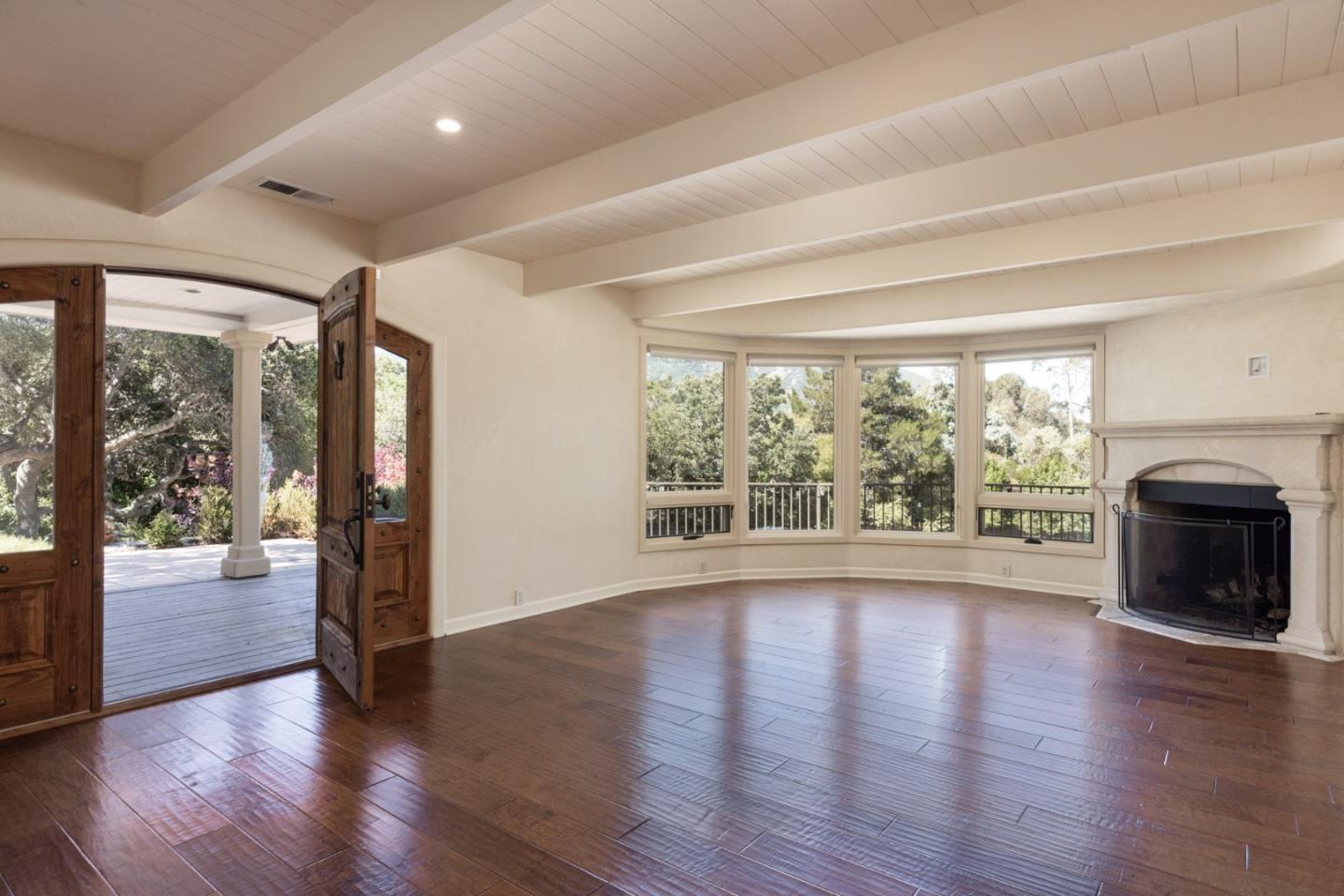 21 La Rancheria Carmel Valley, CA 93924 - Photo 5 of 44 a view of an empty room with wooden floor and a large window