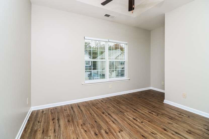 113 Howard Avenue Cartersville, GA 30121 - Photo 13 of 17 an empty room with wooden floor and windows