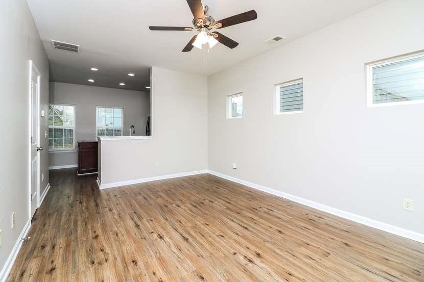 113 Howard Avenue Cartersville, GA 30121 - Photo 8 of 17 an empty room with wooden floor and windows