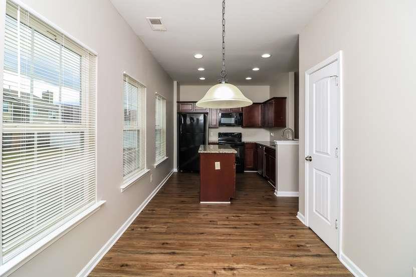 113 Howard Avenue Cartersville, GA 30121 - Photo 10 of 17 a large kitchen with stainless steel appliances granite countertop a stove and a wooden floors