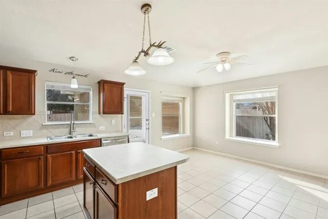 a kitchen with a stove a sink and a refrigerator