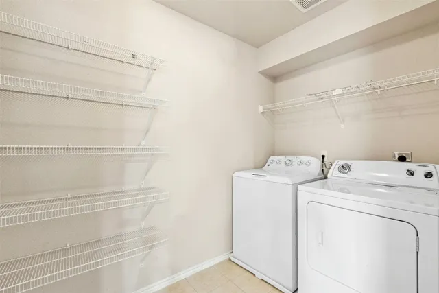 a view of storage and utility room with washer and dryer