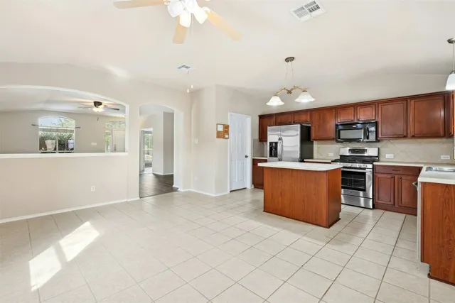 a kitchen with stainless steel appliances granite countertop a stove sink and cabinets