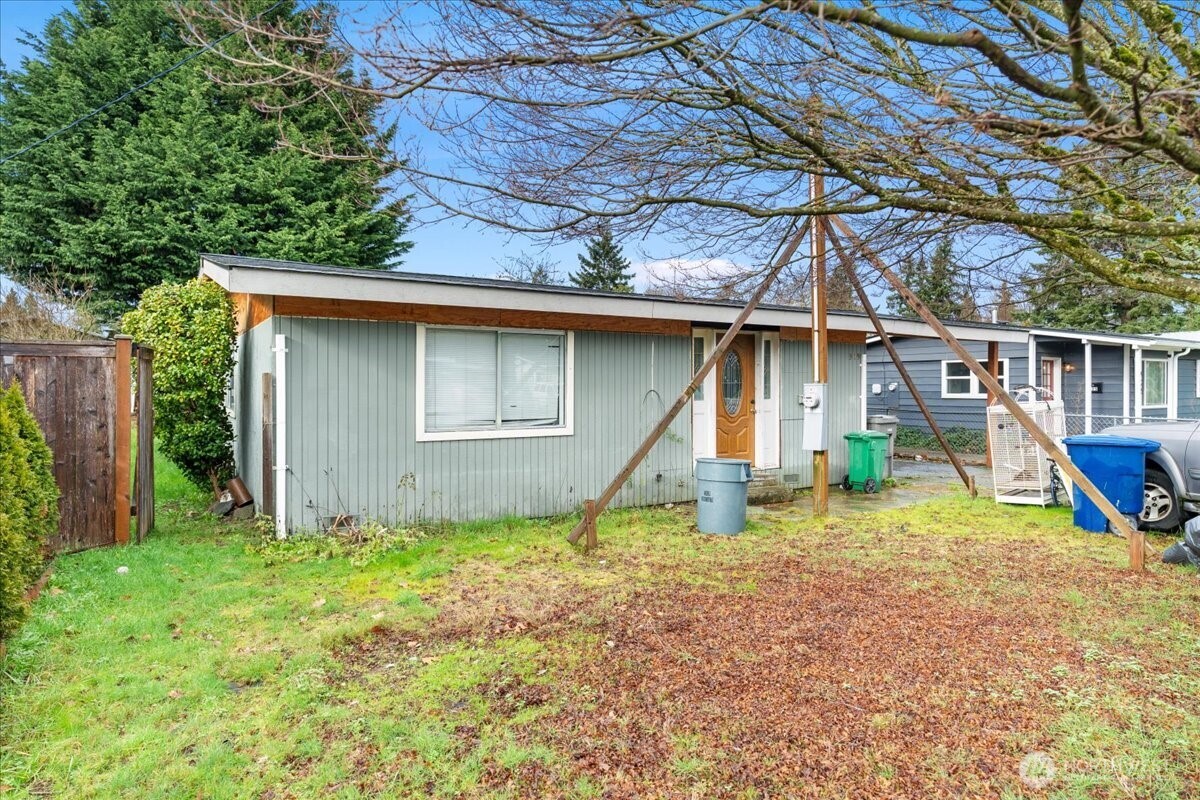 919 Edmonds Avenue Northeast Renton, WA 98056 - Photo 12 of 15 a view of a house with backyard and trees