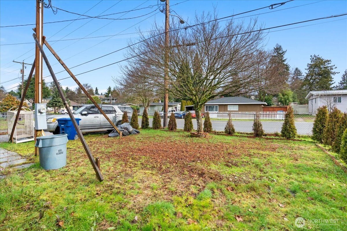 919 Edmonds Avenue Northeast Renton, WA 98056 - Photo 15 of 15 a backyard of a house with fountain plants and large tree
