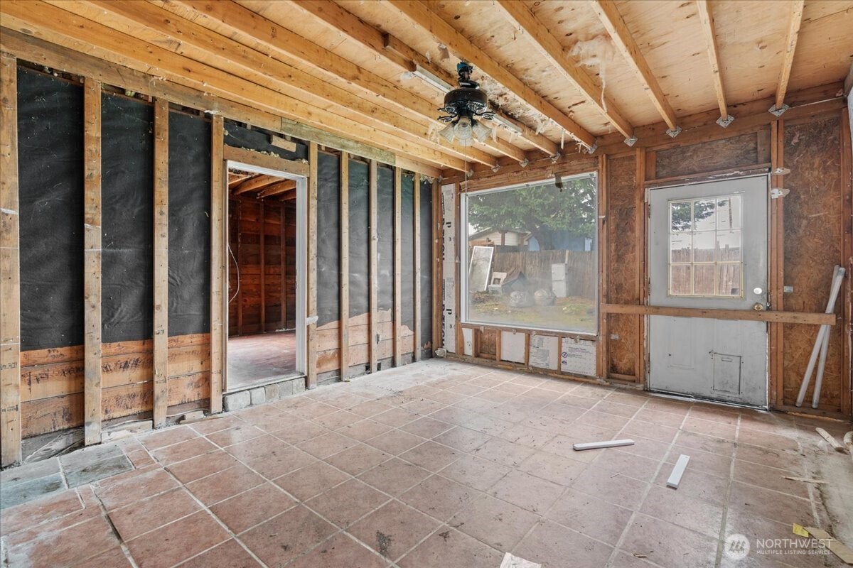 919 Edmonds Avenue Northeast Renton, WA 98056 - Photo 6 of 15 a view of a porch with wooden floor and roof