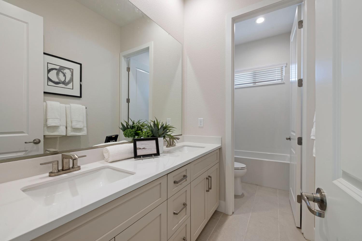 2252 Lyndon Street Lodi, CA 95242 - Photo 5 of 23 a bathroom with a double vanity sink a mirror and a bathtub