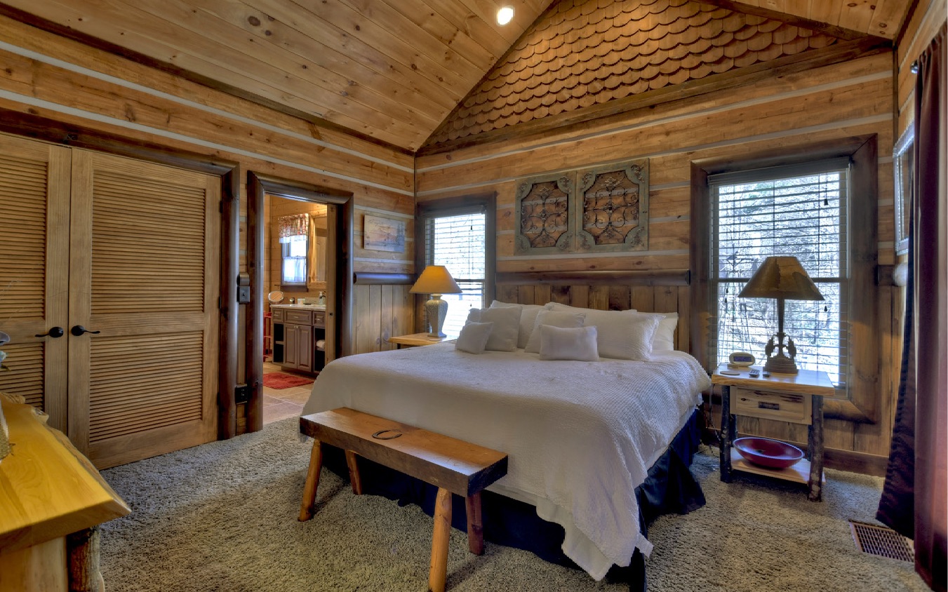 2124 Maxwell Road Blue Ridge, GA 30513 - Photo 27 of 66 a bedroom with a bed and a table