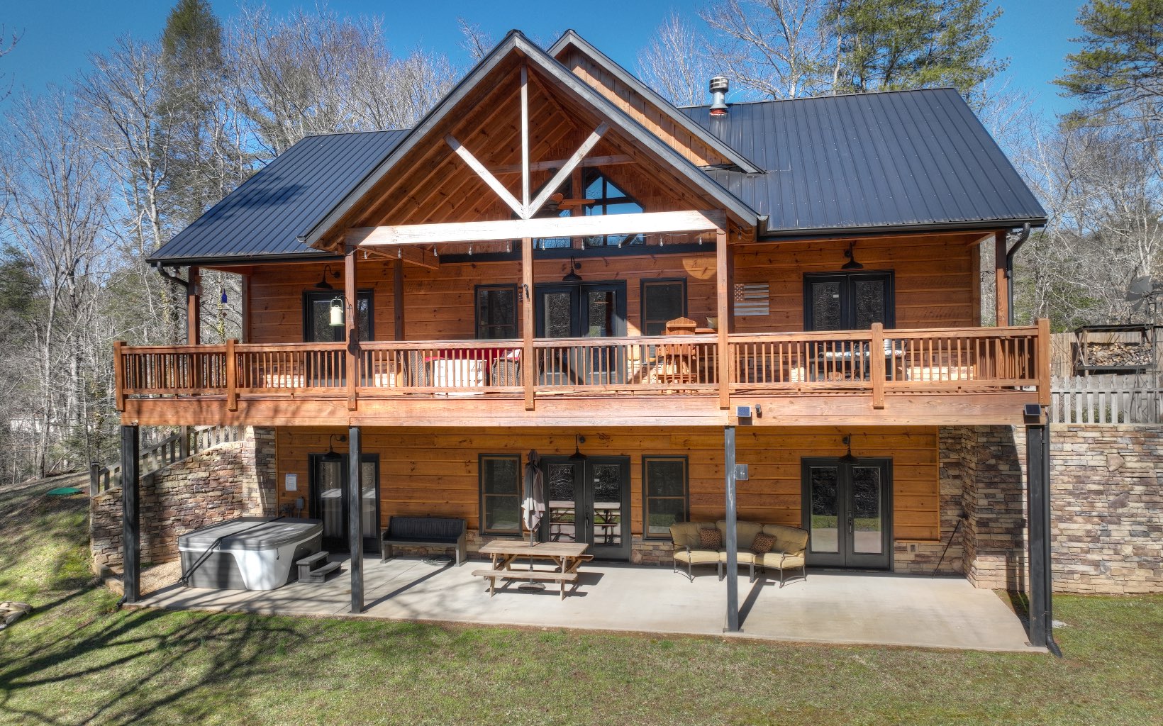 2124 Maxwell Road Blue Ridge, GA 30513 - Photo 48 of 66 a patio with a table and chairs and potted plants