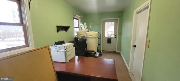 a view of a hallway with a view of living room