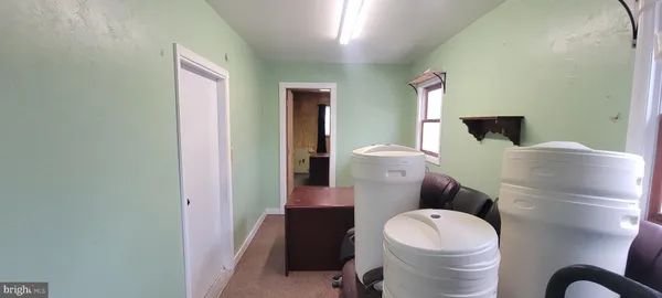 a white toilet sitting next to a bathroom sink and a mirror
