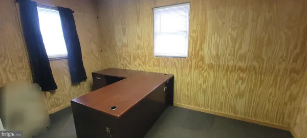 a kitchen with a refrigerator stove and wooden floor