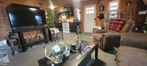 a kitchen filled with a refrigerator and a table